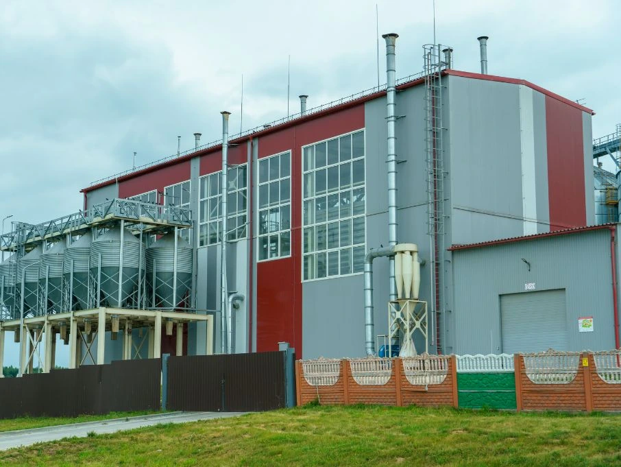 A large multi-storey industrial building featuring a prominent red roof