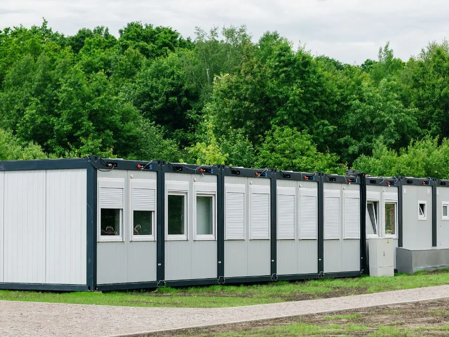 Modular buildings arranged in a field, representing the work of a prefabricated Porta Cabin building manufacturer