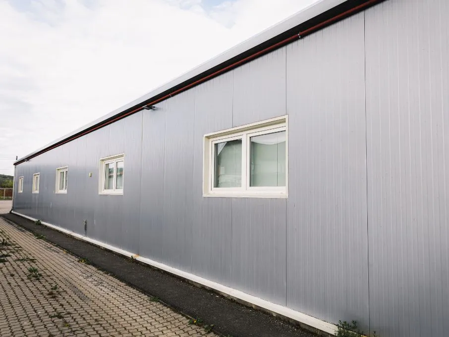 Prefabricated porta cabin with a sandwich wall and multiple windows, showcasing modern design and functionality