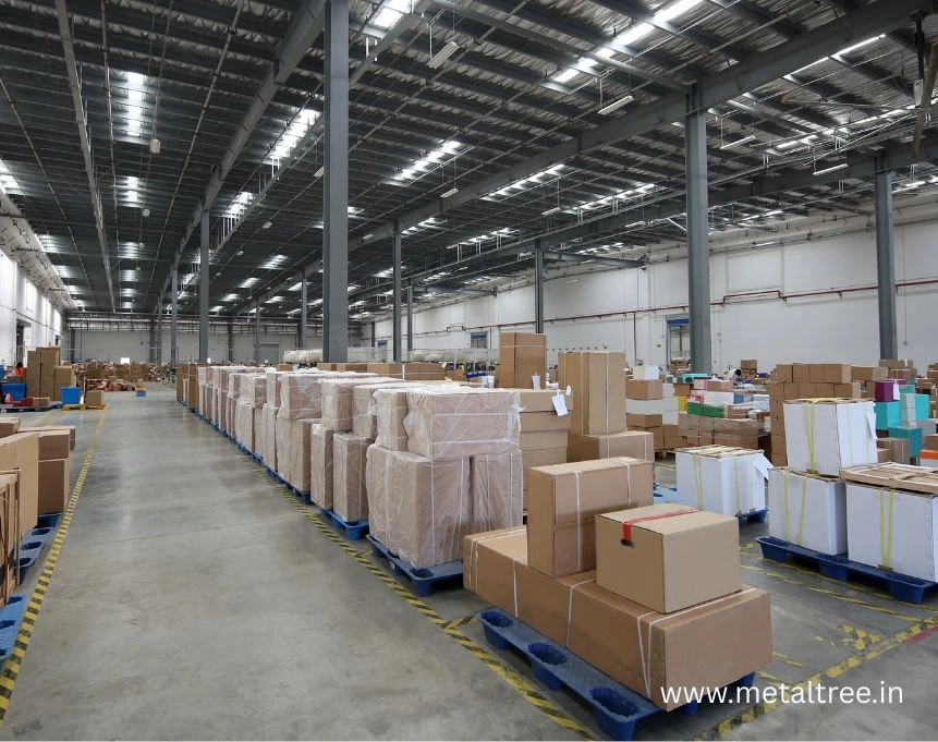 Interior view of PEB factory shed showing exposed steel beam ceiling structure and clear span design for maximum operational flexibility