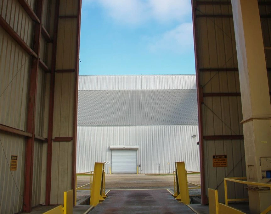Pre-Engineered Building Manufacturer performing quality control checks on steel components