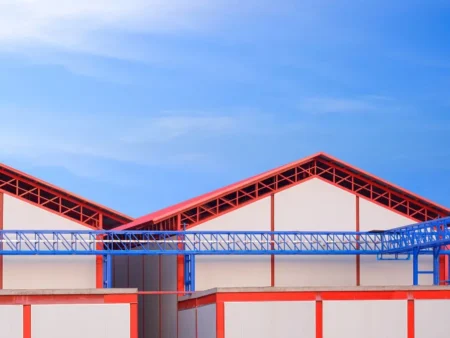 A Large Warehouse Featuring Red And Blue Roofs Showcasing Prefabricated Portable Buildings