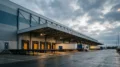Exterior Shot Of A Large Warehouse Loading Dock With Multiple Trucks Parked